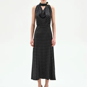 Top nero a pois con collo drappeggiato